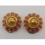 A pair of 19th century yellow metal (tests as high carat gold) and ruby ear clips, of boss form,