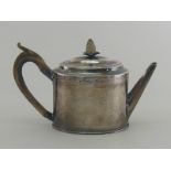 A George III silver oval drum teapot with bright cut engraving and ivory pineapple finial.