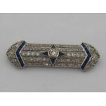 An Art Deco 18 carat white gold, sapphire and diamond bar brooch,