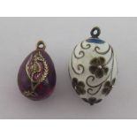 Two enamel egg charms, the first of purple guilloche enamel with a seahorse motif, 21.