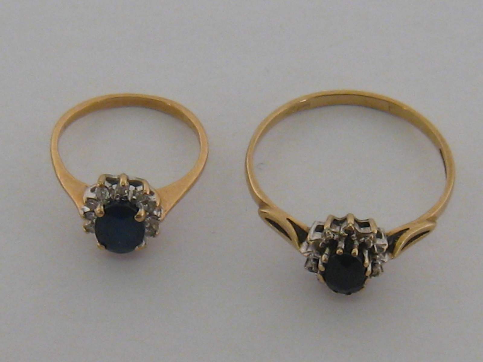 Two sapphire and diamond cluster rings, the first with a 7.4mm x 5.
