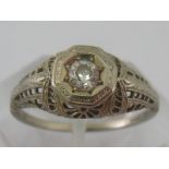 A white metal (tests 18 carat gold) diamond solitaire ring,