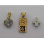 Three small gold and diamond set pendants, two marked as 18 carat gold,