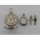 A late 19th century ornate silver fob watch, with white enamel dial,