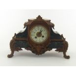 A bronzed metal mounted marble mantel clock,