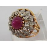 An 18 carat yellow gold, platinum, ruby and diamond dress ring, the central cabochon 7.