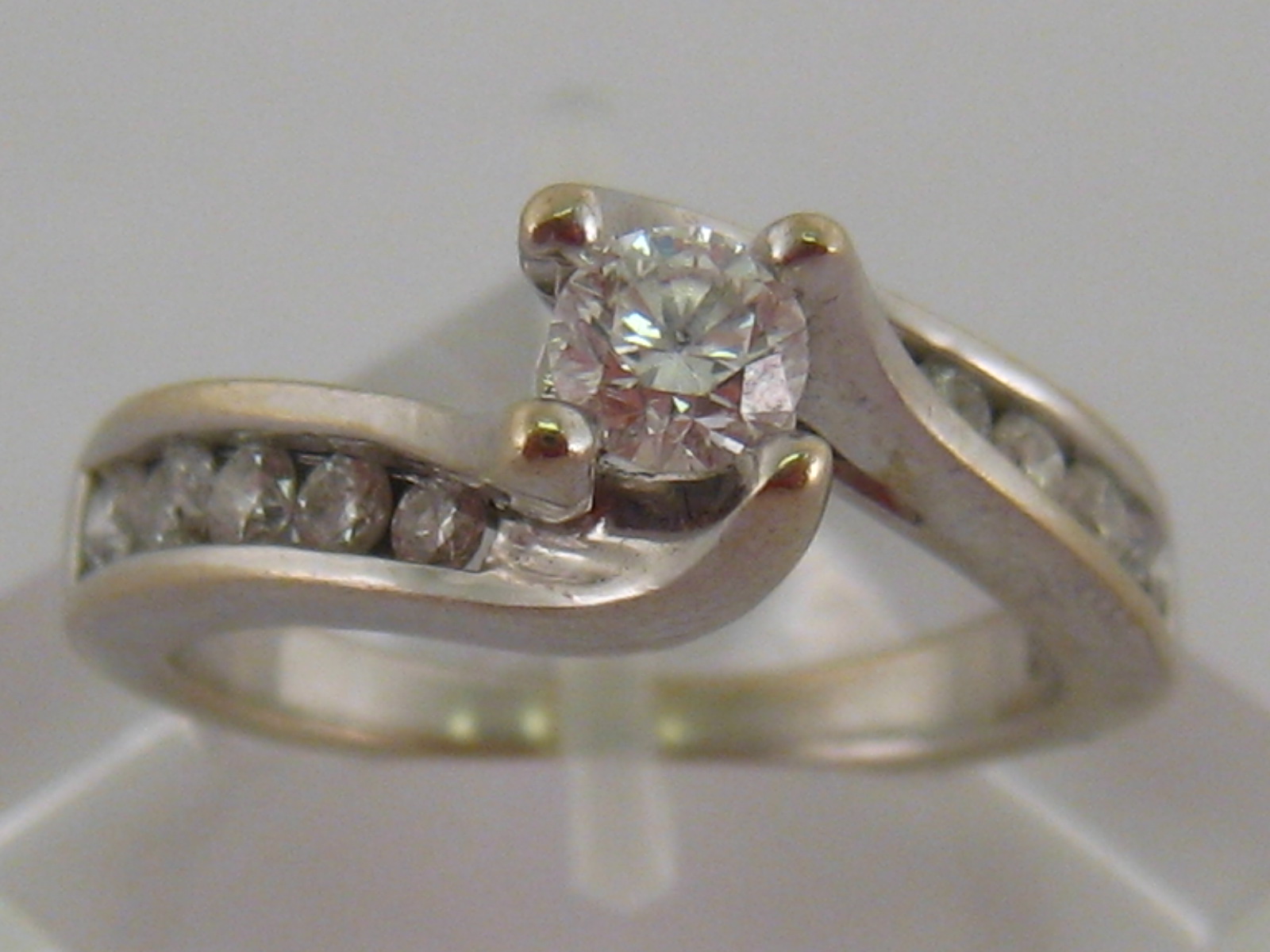 A 14 carat white gold and diamond ring, the central brilliant approx. 0.
