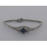 An Art Deco platinum, sapphire and diamond bracelet, the central cabochon sapphire 7.5 x 6.