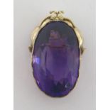 A 9 carat and amethyst pendant, the amethyst 35mm long, the mount crowned with a floral garland,