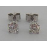 A pair of single stone diamond ear studs, each brilliant approx. 0.