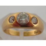 A 14 carat gold and three stone diamond ring, the central collet set old cut approx. .