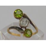 A diamond and peridot ring, the central cushion cut approx. 0.