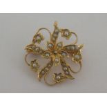 A late 19th century 15 carat yellow gold and seed pearl flower brooch, stamped '15ct',