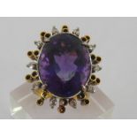 An amethyst and diamond dress ring, the large oval cut stone 7.5 x 3.