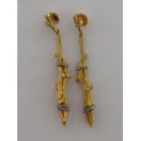 A pair of 18 carat yellow gold and diamond earrings, designed as a pair of bound twigs,