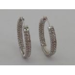 A pair of 18 carat white gold and diamond ear hoops,