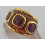 ADLER, an 18 carat yellow gold and red stone dress ring, signed and numbered 5462, finger size H/I,