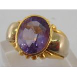 An Italian 18 carat gold and amethyst dress ring, the oval cut stone approx.