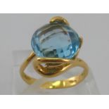 A yellow metal (tests 18 carat gold) blue topaz ring, topaz approx 12mm diameter, ring size M, 5.