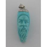 An 18 carat white gold, diamond and carved turquoise pendant, the turquoise modelled as a sage,