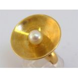 A 1960s 18 carat gold and cultured pearl ring by Georg Jensen, design by Nanna Ditzel, the concave
