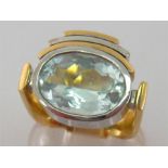 A yellow metal (tests 14 carat) aquamarine dress ring, the oval stone 14.7 x 10.4 x 7 (deep) mm