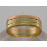 A 14 carat three colour gold ring, with squared outer band, stamped ‘14k’, finger size N/O, 5gms