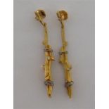 A pair of 18 carat yellow gold and diamond earrings, designed as a pair of bound twigs, each