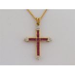 An 18 carat gold, ruby and diamond cross pendant, set overall with calibre cut rubies, to eight-