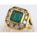 An 18 carat gold, emerald and diamond ring, the square cut stone 7.4 x 7.4 x 5.1 (deep) mm, in a