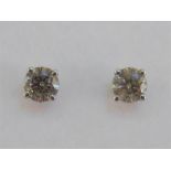 A pair of single stone diamond ear studs, each brilliant approx. 0.5 carat, mounted in 14 carat