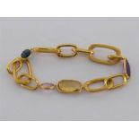 An 18 carat gold and multi gem bracelet by Marco Bicego, the large textured chain set at intervals