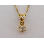 A French 18 carat gold and diamond pendant, the drop claw set with an old cut 4mm (diameter) x 3.1