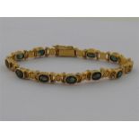 A yellow metal (tests 18 carat gold) tourmaline bracelet, approx. 17.5cm long, 20.1gms.