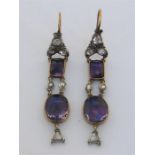 A pair of 19th century amethyst and rose cut diamond earrings, each composed of a gold backed oval