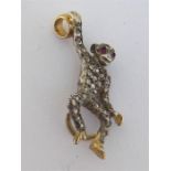 A Victorian rose cut diamond and ruby monkey pendant, pave set overall with rose cuts, and ruby