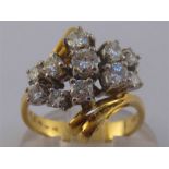 An 18 carat gold and diamond ring, set to the centre with a cluster of brilliants totalling