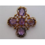 A late Georgian gold filigree and amethyst brooch/pendant, circa 1820, composed of a cross of oval