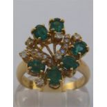 An Italian 18 carat gold giardinetti style diamond and emerald cluster ring, composed of a spray
