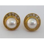 A pair of yellow gold (tests 18 carat), mabe pearl and diamond ear studs, the off-set mabe pearls