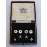 An Art Deco 18 carat gold, platinum, mother-of-pearl and sapphire cufflink and stud set, the