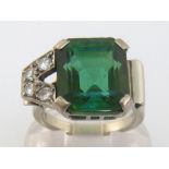 An 18 carat white gold, green tourmaline and diamond ring, the asymmetrical design with off-set