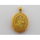 A Victorian gold locket, the oval body (tests 15 carat) richly chased and engraved overall, 4.4cm