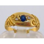 An Edwardian 18 carat gold, sapphire and diamond ring, the central oval cut stone gypsy set