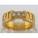 An 18 carat gold and diamond ring, in the Tiffany ‘Atlas’ style, set to the centre with three