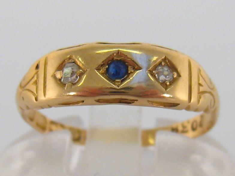 A late Victorian 18 carat gold, diamond and sapphire ring, the three small gypsy set stones