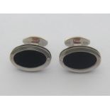 A pair of Italian 18 carat white gold and black rubber cuff links, the oval cuffs 18mm long, Italian