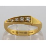 An 18 carat gold and diamond five stone ring, the five graduated diamonds in a tapering pave