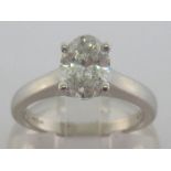 An 18 carat white gold and single stone diamond ring, the central oval cut approx. 1.15 carat, the