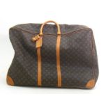 Louis Vuitton:- A brown coated canvas and leather lady’s monogrammed keepall travel bag, approx.